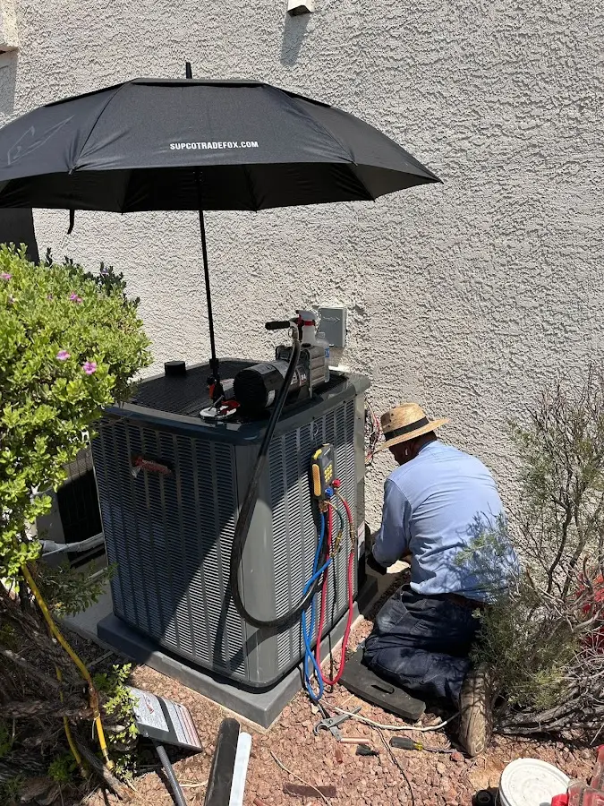 HVAC technician performing outdoor AC maintenance in Sun Prairie