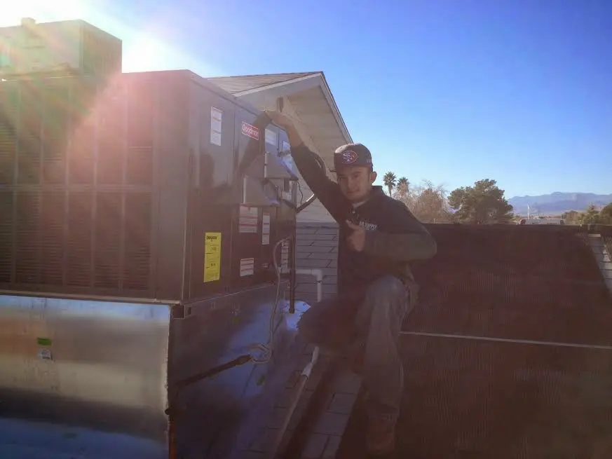 HVAC technician performing HVAC Inspection on a rooftop unit in Sun Prairie